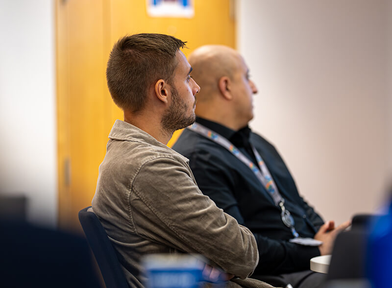 Two students, learning in a classroom.